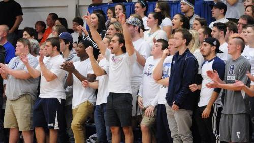 Rivier students cheering during the home sporting event